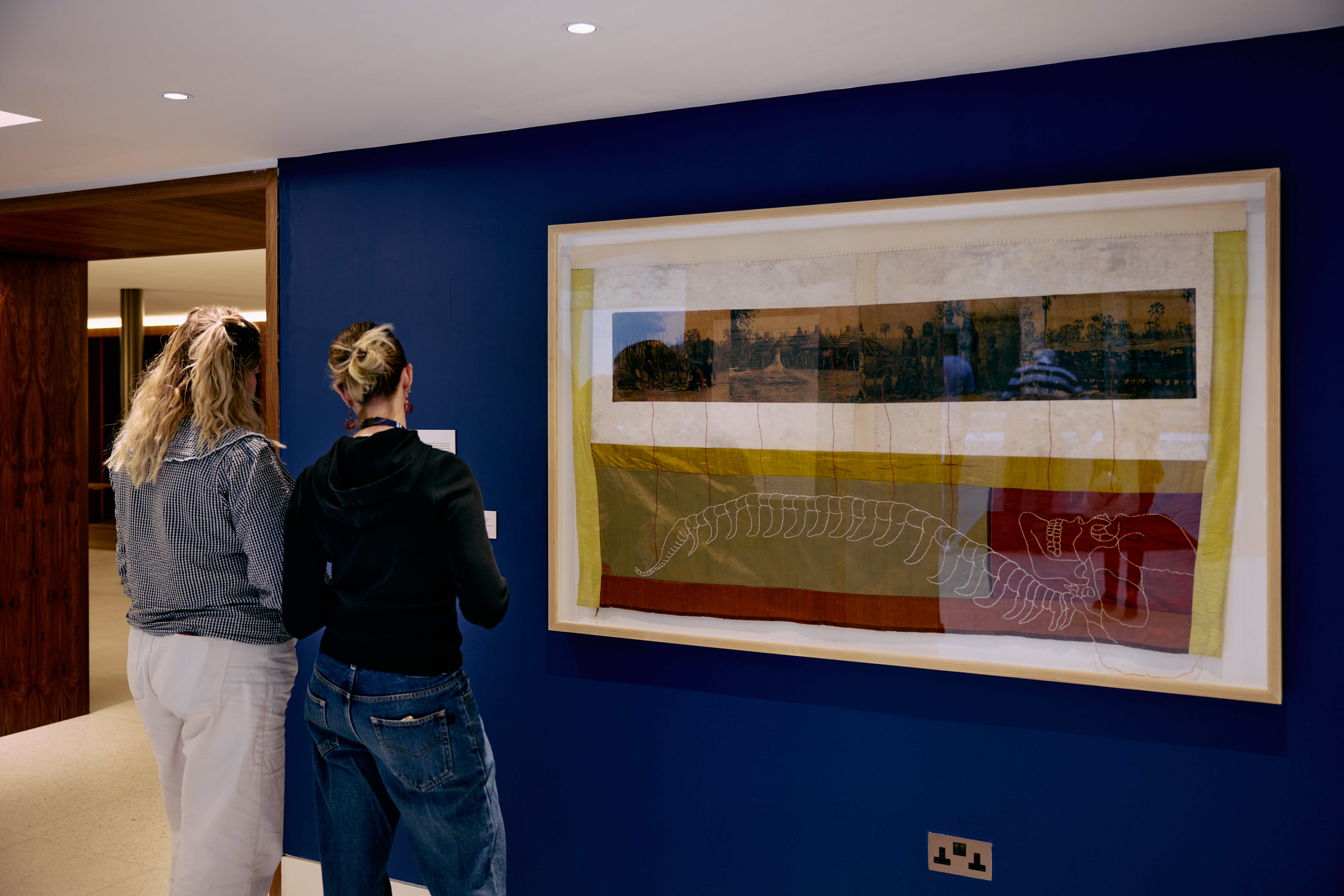 Two women viewing Tuli Mekondjo’s artwork
