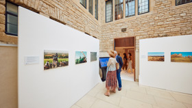 Delegates looking at artwork on the temporary walls set up in the Lightwells.