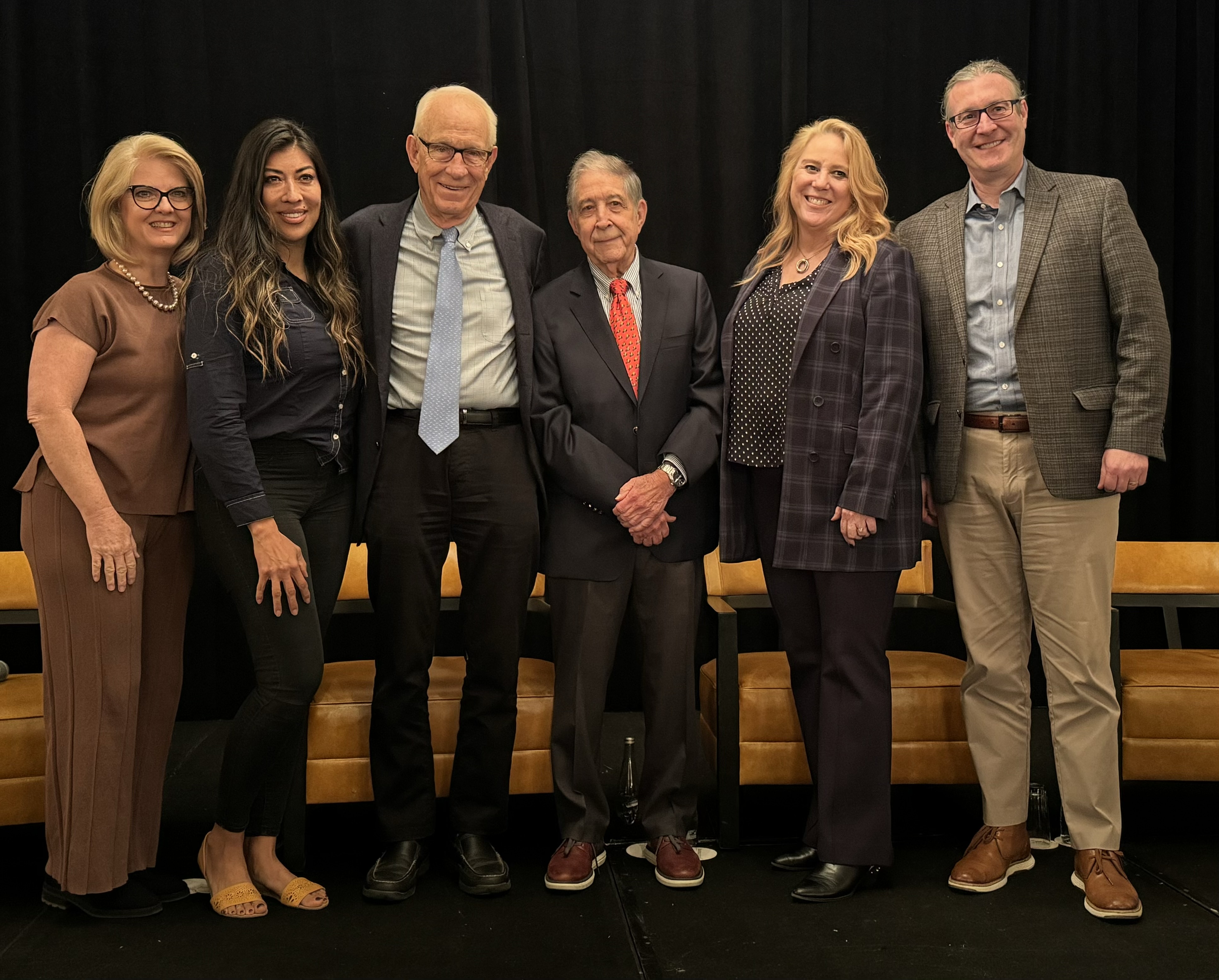 A group of six is pictured standing and smiling, Dayne is stood to the right.
