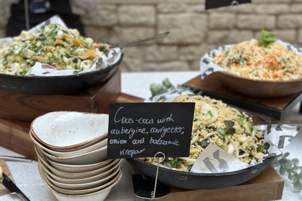 Close up of salads set out as part of a bowl food lunch.