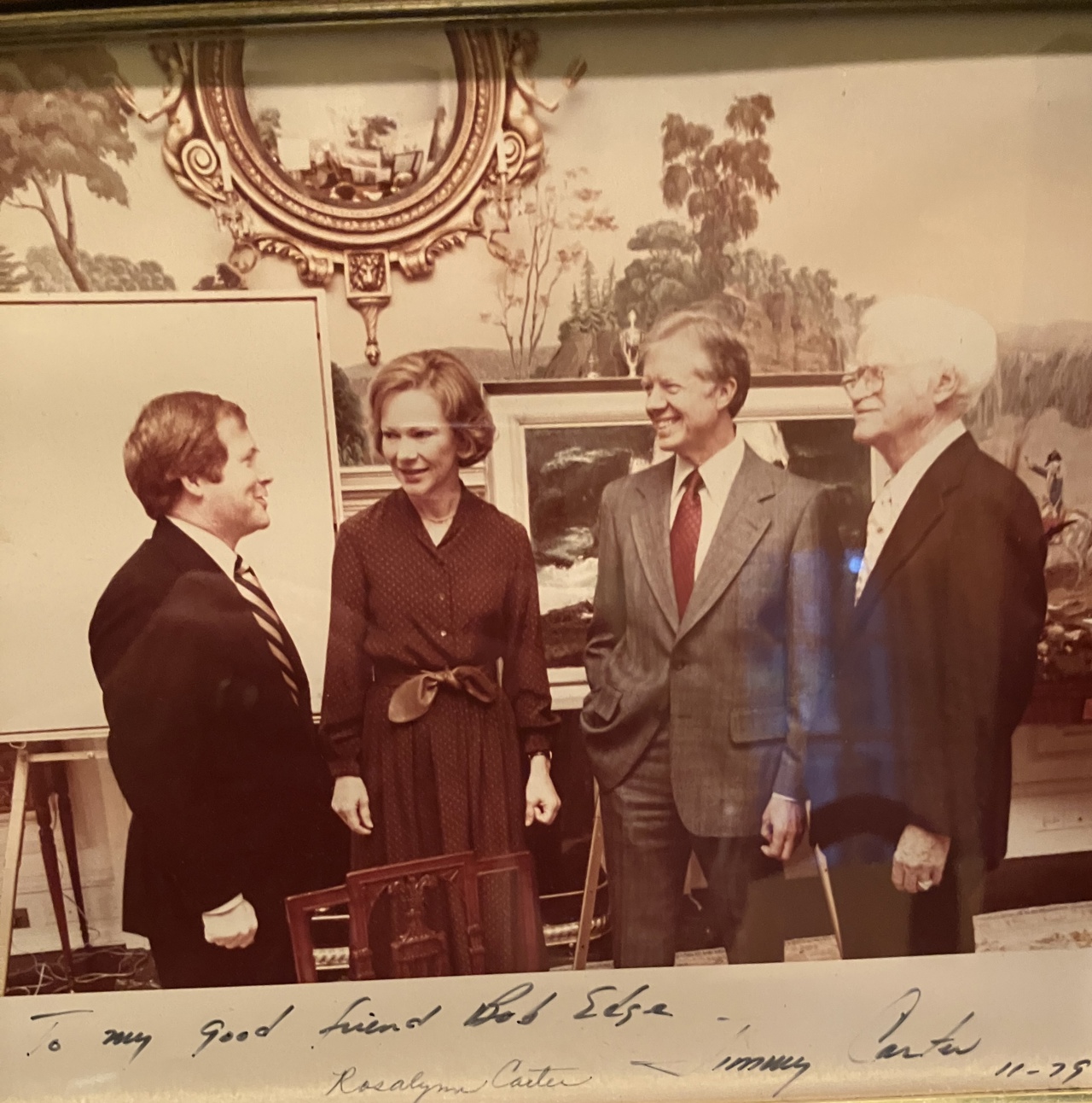 Bob with Rosalynn and Jimmy Carter and another man, dressed in formal attire and surrounded by nature paintings