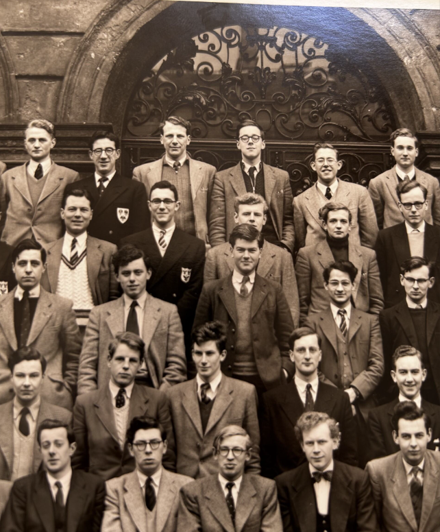 Black and white photo of a group of students posing in their college suits
