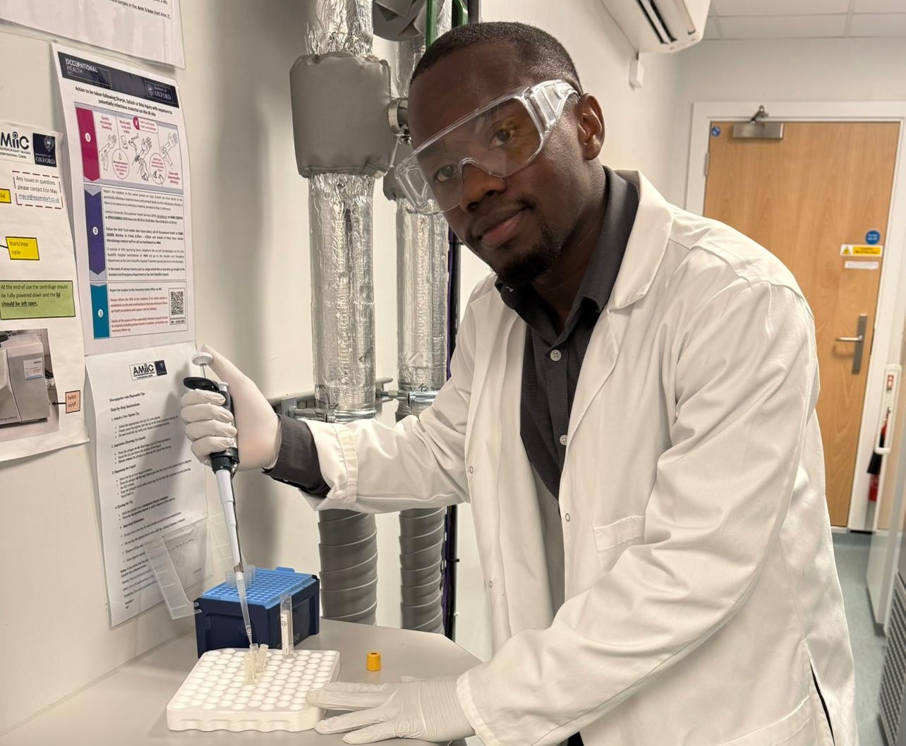 Michael holding a pipette in a lab